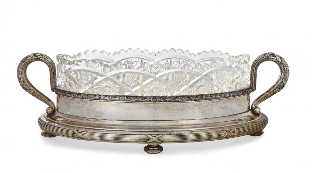 A Russian cut glass dish raised on a silver stand, by Faberge, the navette-shaped cut glass dish