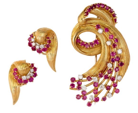 A suite of gold diamond and ruby Jewellery, by Kutchinsky, comprising: an 18ct gold brooch of swirl design with matching earrings, randomly set with rubies and diamonds , all signed Kutchinsky, London hallmarks for 18-carat gold.1977 on offer at Roseberys Jewellery & Watches auction on Tuesday, 30 November 2021