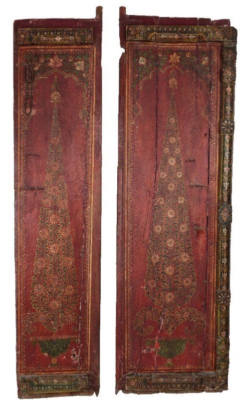 Two Kashmiri painted wood door panels, India, mid-19th century, decorated with floral displays in vases, on a red ground, the reverse plain red, 175cm high, 38.5cm. and 51cm. wide (2)